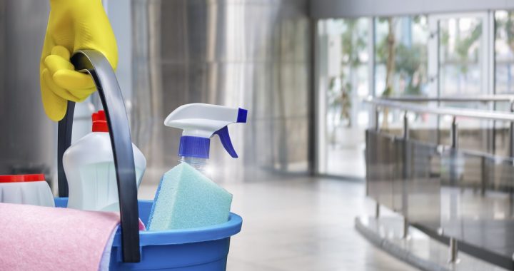 Cleaning lady with a bucket and cleaning products before washing the floor.